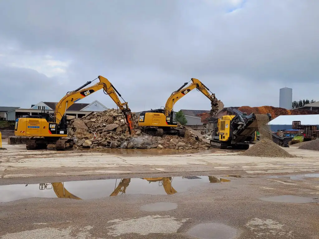 Großflächige Abbruchbaustelle mit mehreren Baggern beim Gebäuderückbau.